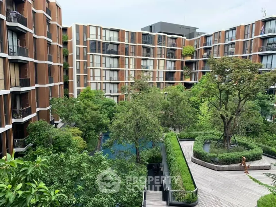 Modern apartment complex with lush greenery and pool view