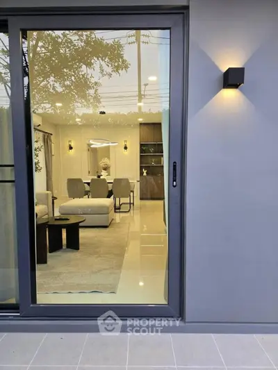 Modern living room with sleek furniture and large glass sliding door