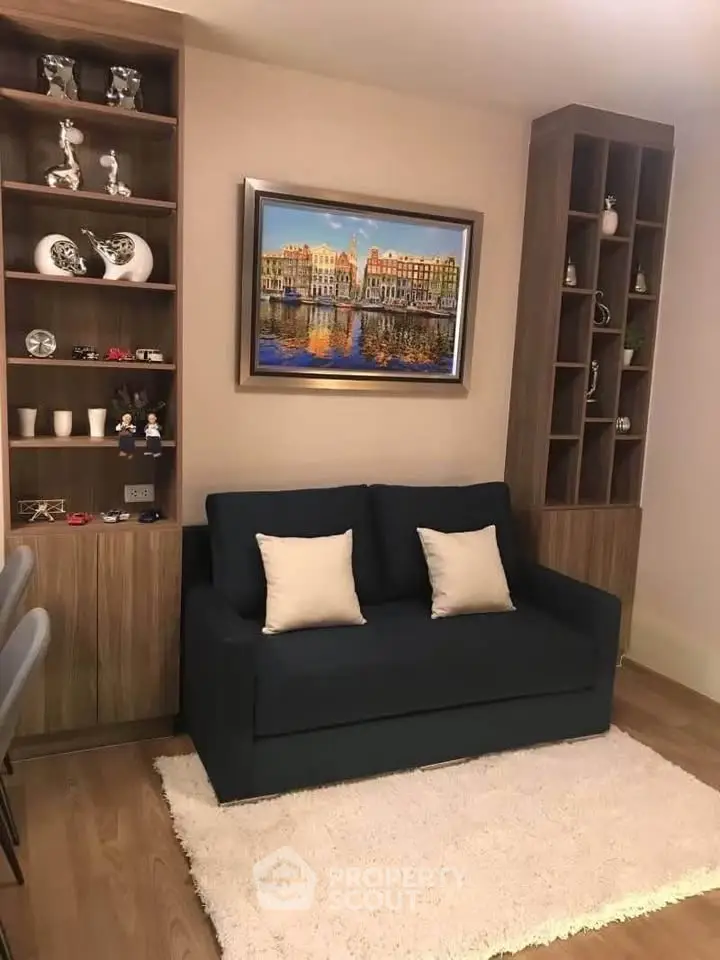 Cozy living room with stylish shelving and a comfortable sofa, perfect for relaxation and entertaining.