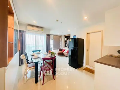 Spacious open-plan living and dining area with modern furnishings and natural light.