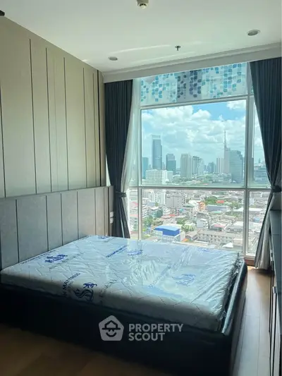 Modern bedroom with stunning city view and large window, featuring a comfortable bed and elegant decor.