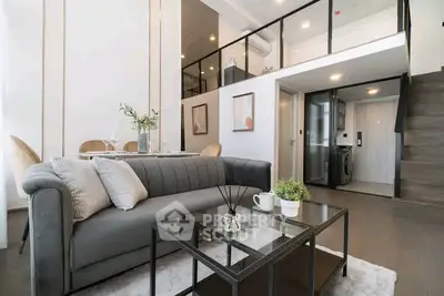 Modern duplex living room with stylish decor and open layout, featuring a cozy sofa and elegant dining area.