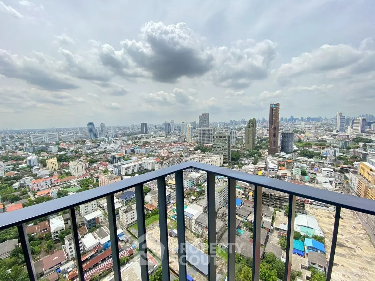 Stunning cityscape view from a high-rise balcony showcasing urban skyline and expansive horizon.