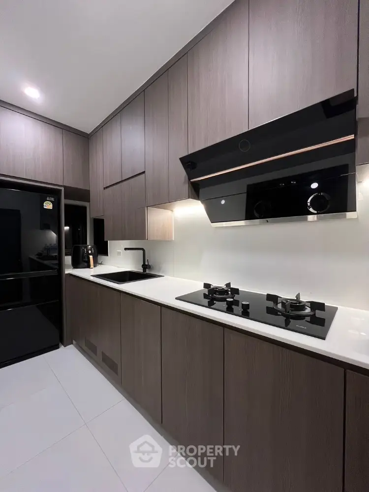 Modern kitchen with sleek cabinetry and gas stove in contemporary home
