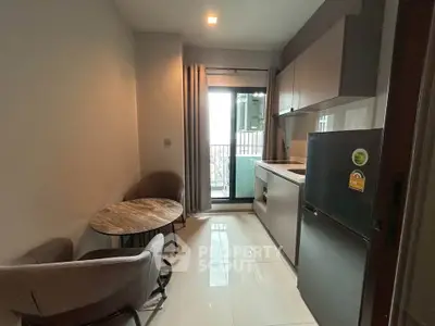 Cozy kitchen with modern appliances and balcony view in a stylish apartment.