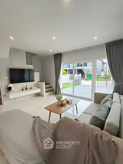 Spacious modern living room with large windows and stylish decor