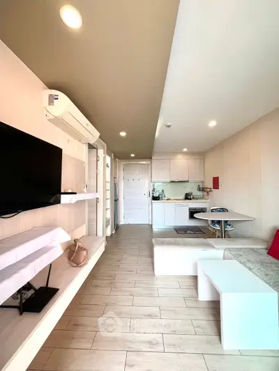 Modern open-layout living room with sleek kitchen and stylish decor