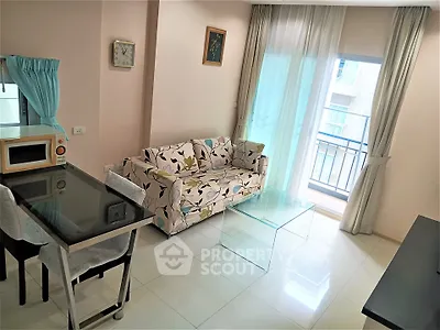 Bright living room with floral sofa and glass coffee table, adjacent to a small balcony.