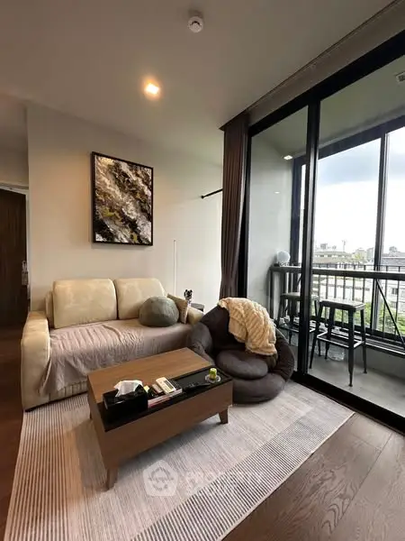 Modern living room with cozy seating and balcony view