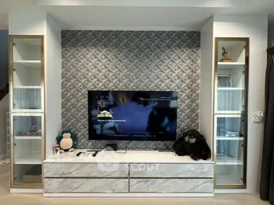 Modern living room with stylish TV unit and decorative shelves