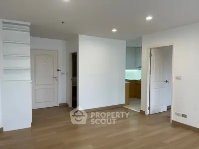 Spacious apartment interior with wooden flooring and modern kitchen