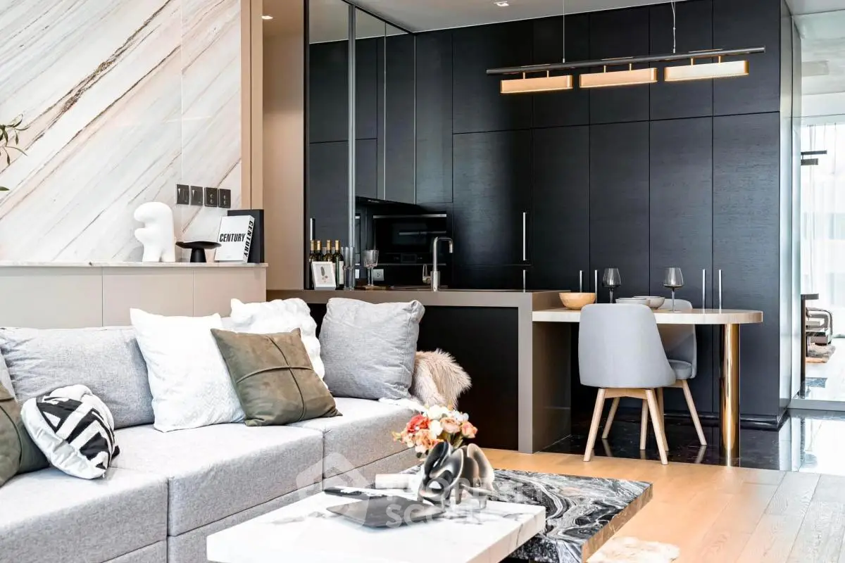 Modern living room with stylish decor and open layout, featuring sleek furniture and elegant lighting.