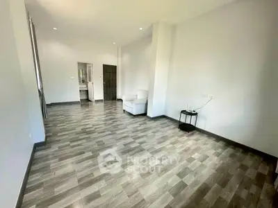 Spacious modern living room with stylish flooring and minimalist decor.