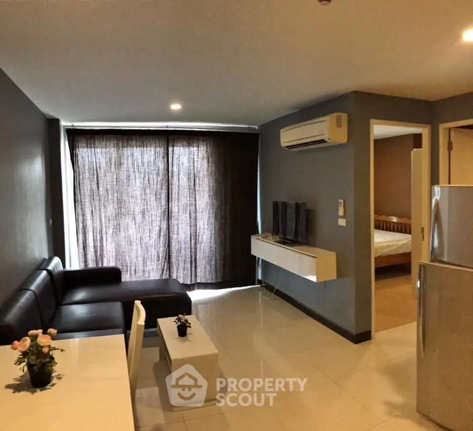 Modern living room with sleek furniture and air conditioning in a stylish apartment.