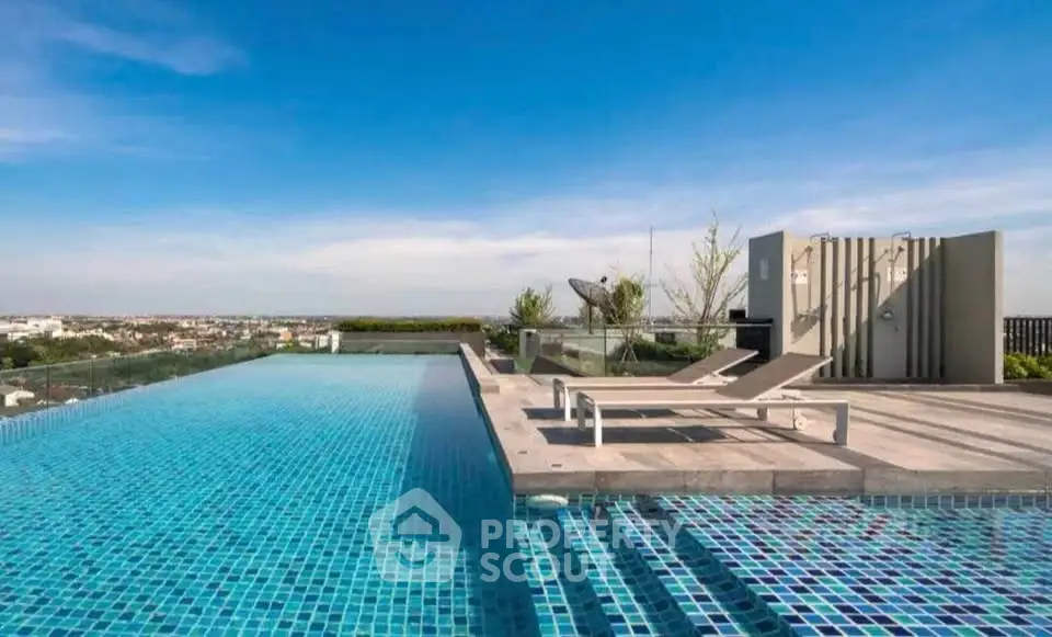 Luxurious rooftop infinity pool with stunning city views and modern lounge chairs.