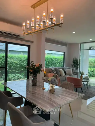 Luxurious modern living room with elegant chandelier and stylish furniture, perfect for sophisticated living.