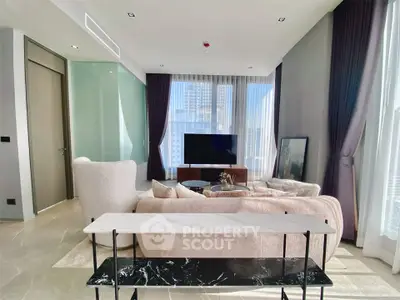 Luxurious modern living room with elegant furniture and large windows offering city views.