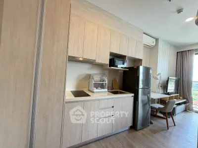 Modern kitchen with sleek cabinetry and integrated appliances in a stylish apartment.