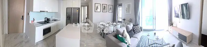 Modern open-plan living room and kitchen with sleek design and natural light