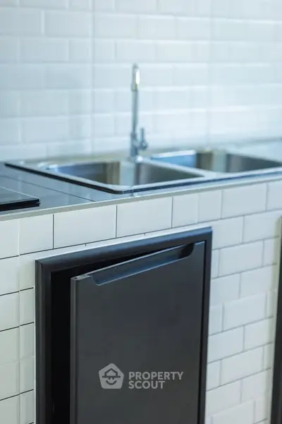 Modern kitchen with sleek stainless steel sink and minimalist design