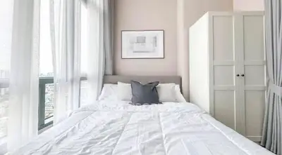 Bright and cozy bedroom with large windows and modern decor