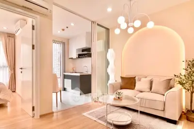 Modern open-plan living room with cozy seating and stylish kitchen area.