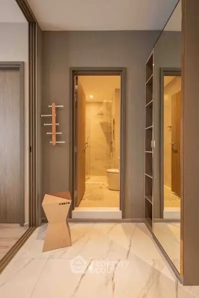 Modern bathroom entrance with sleek design and elegant marble flooring.
