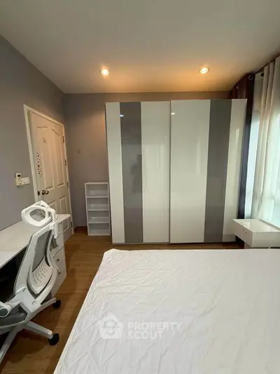 Modern bedroom with sleek wardrobe and study desk, perfect for urban living.