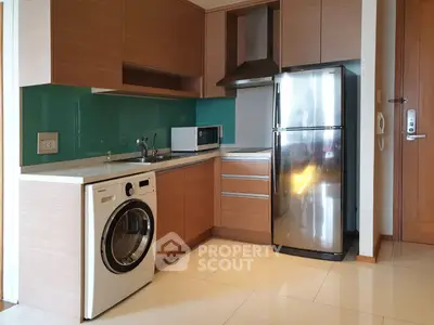 Modern kitchen with sleek appliances and wooden cabinetry in a stylish apartment.
