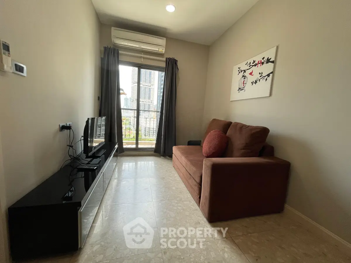 Cozy living room with modern decor and city view, featuring a comfortable sofa and wall art.