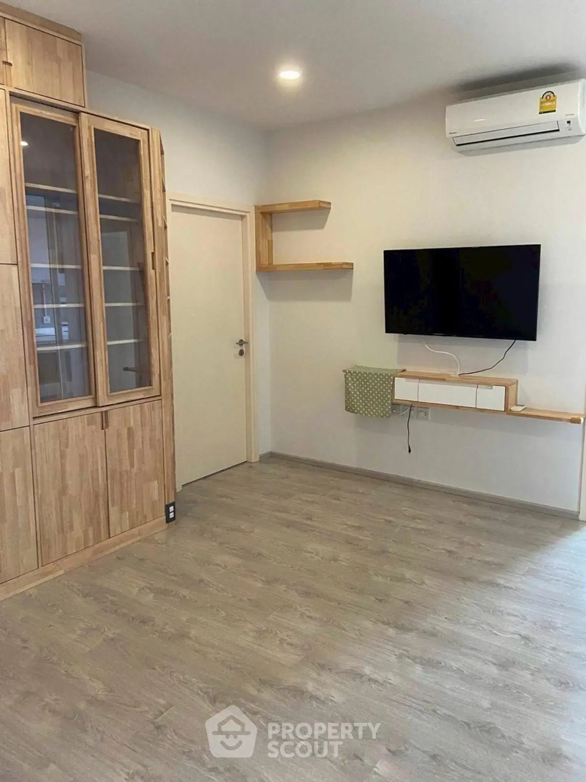 Modern living room with wooden flooring and built-in storage