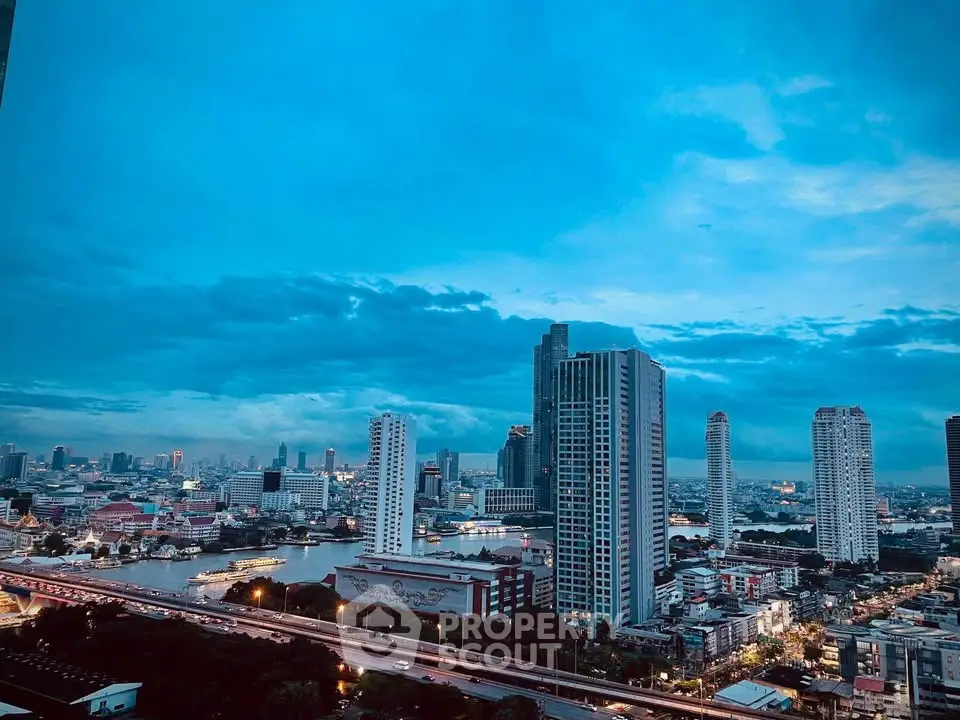 Stunning cityscape view with modern high-rise buildings and river at dusk.