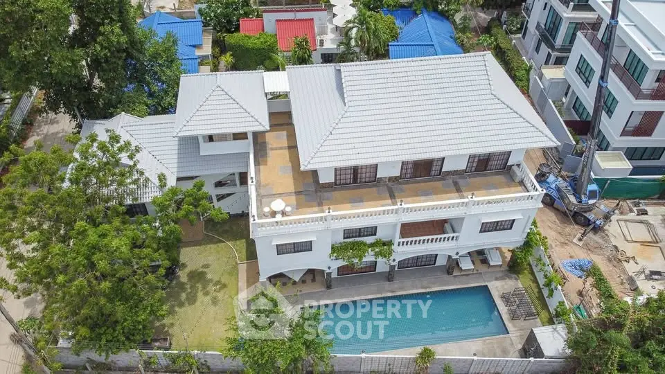 Stunning aerial view of a luxurious villa with a private pool and spacious terrace.