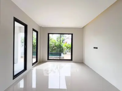 Spacious modern living room with large windows and garden view