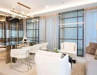 Luxurious modern living room with elegant decor and floor-to-ceiling windows.