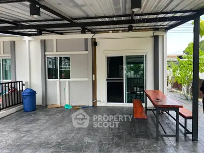 Spacious covered patio with modern design and outdoor seating area.