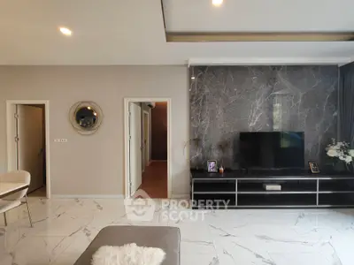 Modern living room with marble accent wall and sleek TV setup