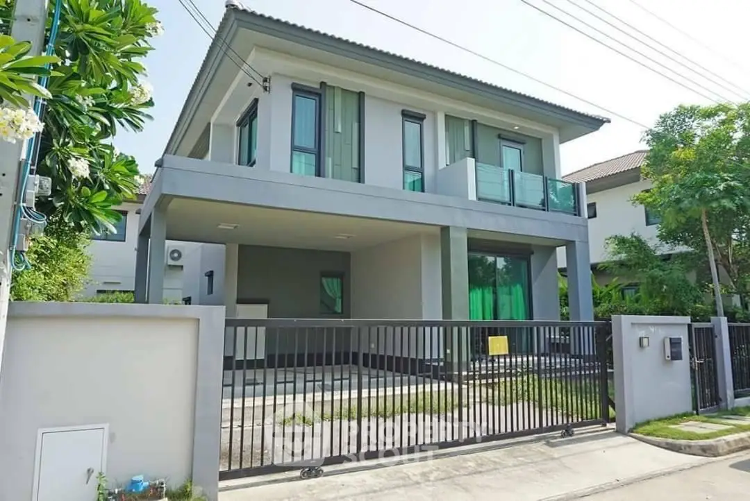 Modern two-story house with sleek design and spacious driveway in a serene neighborhood.