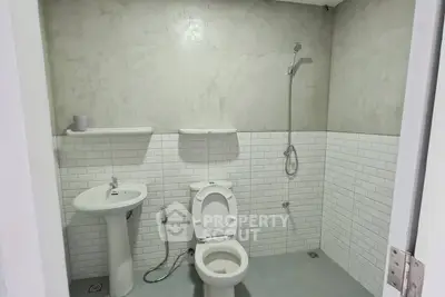 Modern minimalist bathroom with white tiles and sleek fixtures