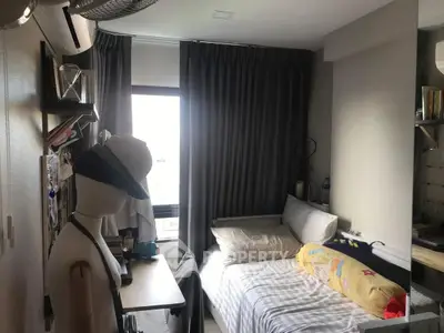 Cozy bedroom with single bed and study desk, ideal for compact living spaces.