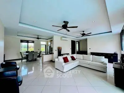 Spacious modern living room with elegant white sofa and dining area