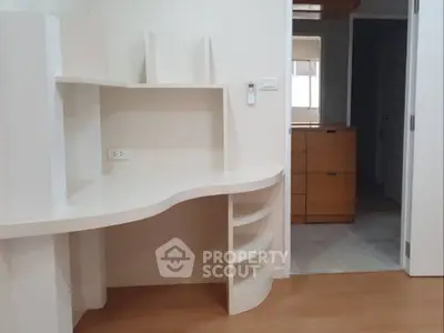 Modern study area with built-in desk and shelves in a bright apartment