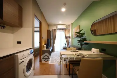 Modern apartment interior with open layout, featuring a washing machine and stylish decor.