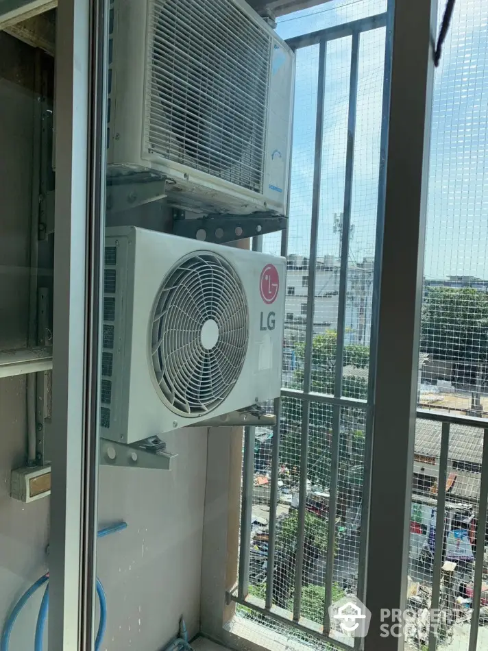 Air conditioning units on a balcony with city view, perfect for urban living comfort.