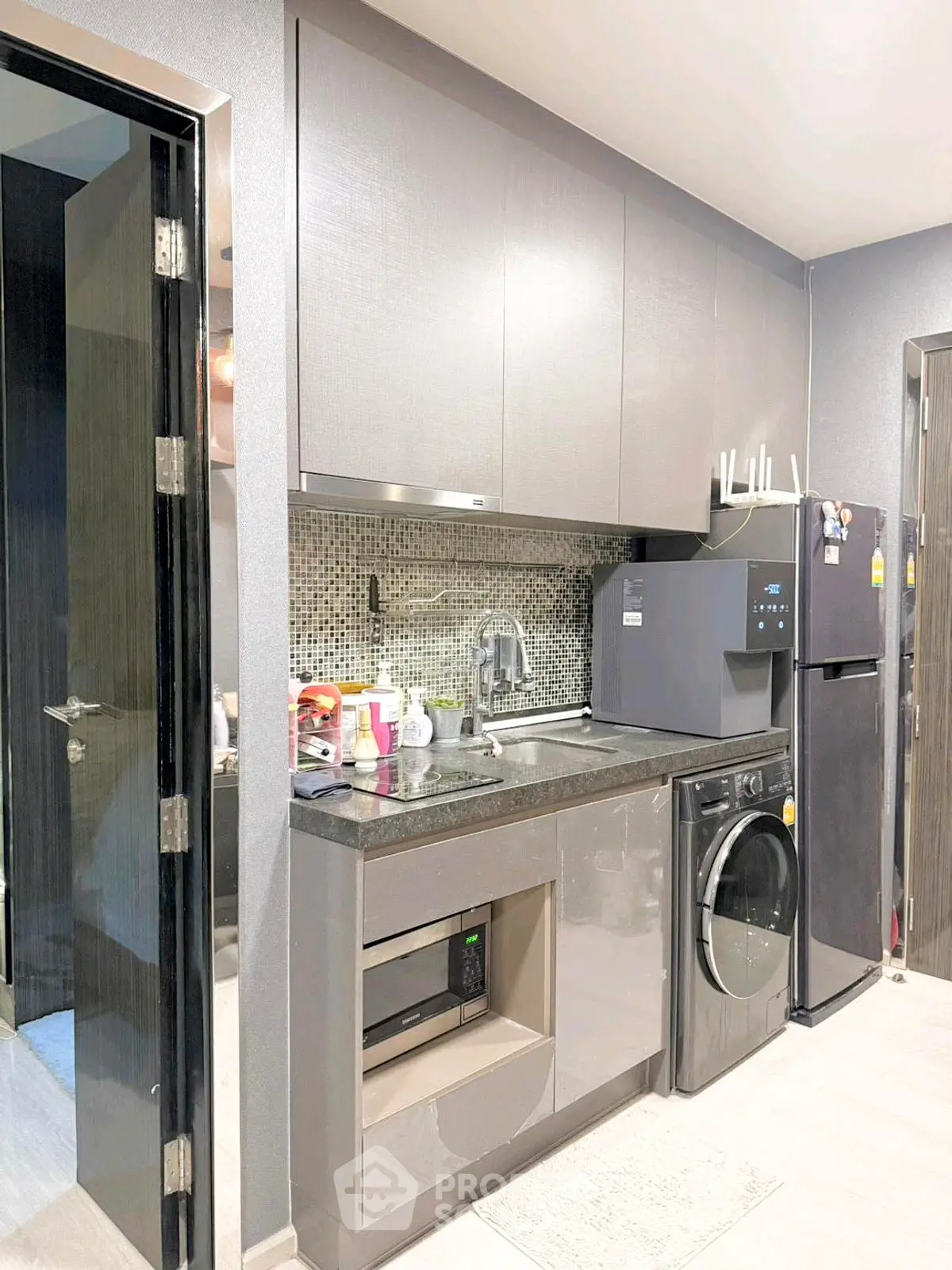 Modern compact kitchen with sleek cabinets and built-in appliances