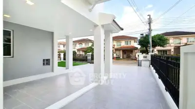 Spacious modern home exterior with covered patio and driveway in suburban neighborhood.