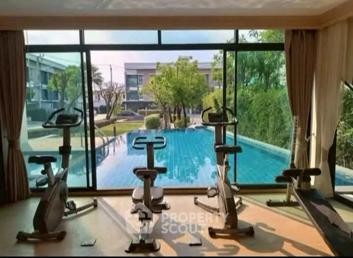 Modern gym with pool view in luxury real estate property