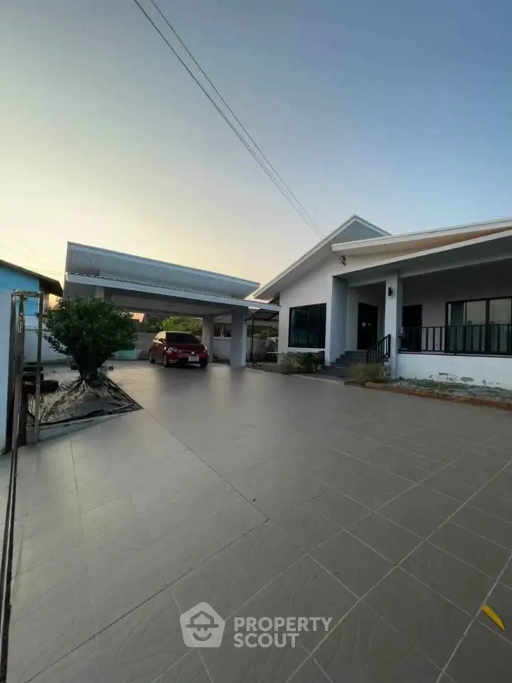 Spacious modern home with large driveway and carport, perfect for family living.