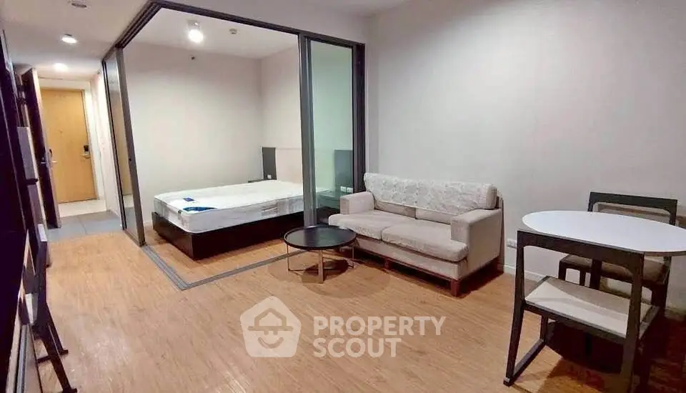 Modern studio apartment with open layout featuring a cozy living area and bedroom, ideal for urban living.
