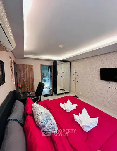 Luxurious bedroom with red bedding and modern decor